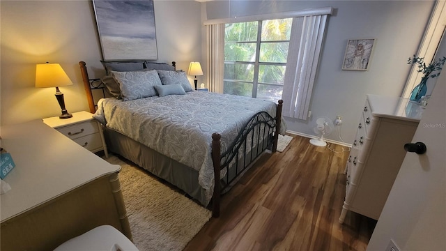 bedroom with dark wood-type flooring