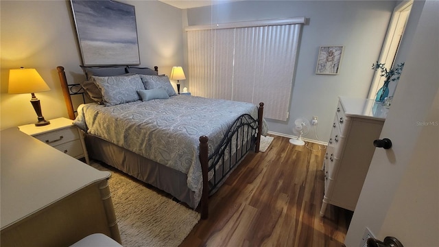 bedroom with dark wood-type flooring