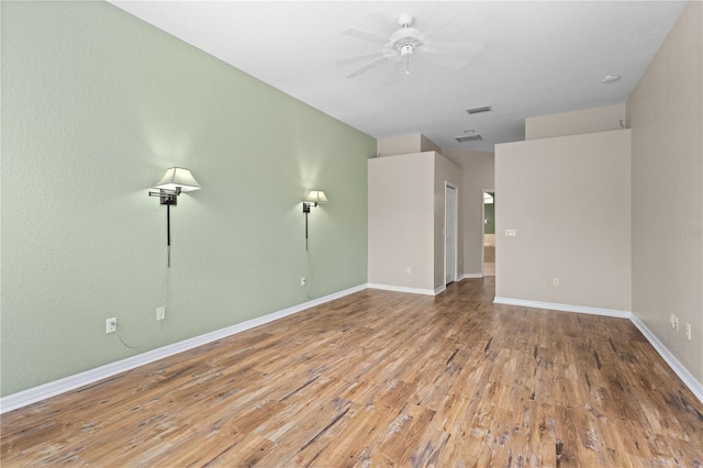 spare room with hardwood / wood-style floors and ceiling fan