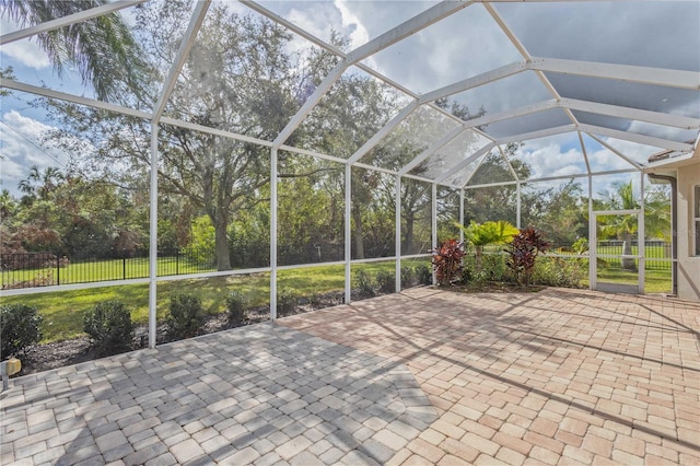 unfurnished sunroom featuring vaulted ceiling