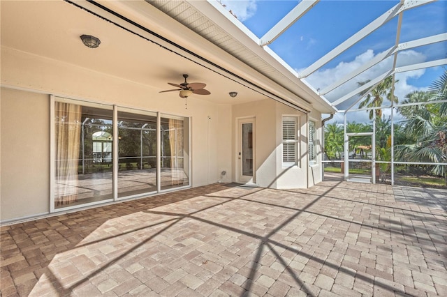 view of patio / terrace featuring glass enclosure and ceiling fan