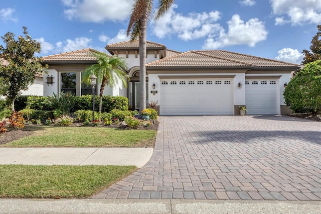 mediterranean / spanish-style home with a garage