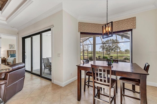 tiled dining area featuring ornamental molding, plenty of natural light, and an inviting chandelier