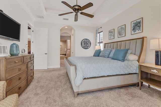 carpeted bedroom with ornamental molding, ceiling fan, and ensuite bath