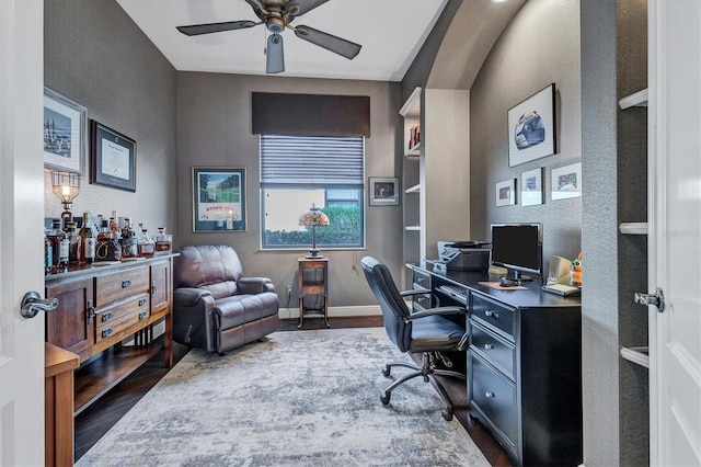 office area featuring lofted ceiling, ceiling fan, and dark hardwood / wood-style flooring