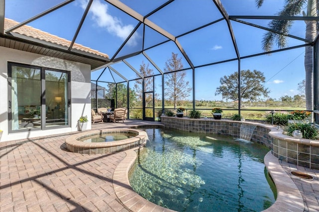 view of pool with a patio, a lanai, pool water feature, and an in ground hot tub