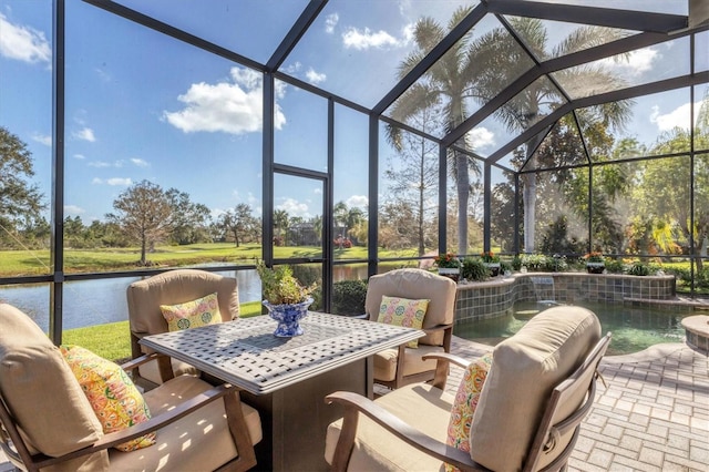 view of patio / terrace featuring a water view, glass enclosure, and pool water feature