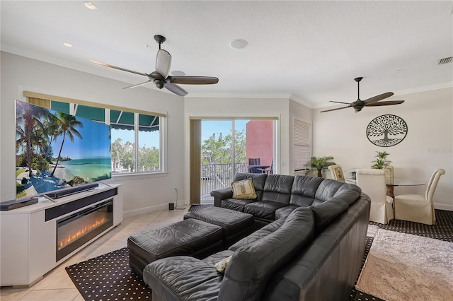 467 Canal Rd Unit 467, Sarasota, FL 34242 - living area with ceiling fan, crown molding, light tile patterned floors, a glass covered fireplace, and baseboards