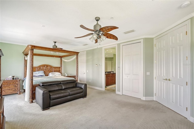 467 Canal Rd Unit 467, Sarasota, FL 34242 - bedroom featuring light colored carpet, baseboards, crown molding, a ceiling fan, and multiple closets