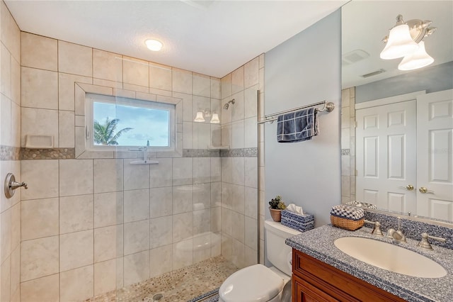 467 Canal Rd Unit 467, Sarasota, FL 34242 - bathroom featuring vanity, tiled shower, and toilet