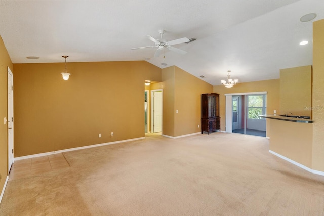 unfurnished living room with lofted ceiling, light carpet, and ceiling fan with notable chandelier