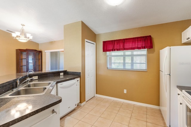 kitchen with vaulted ceiling, an inviting chandelier, white cabinets, sink, and white appliances