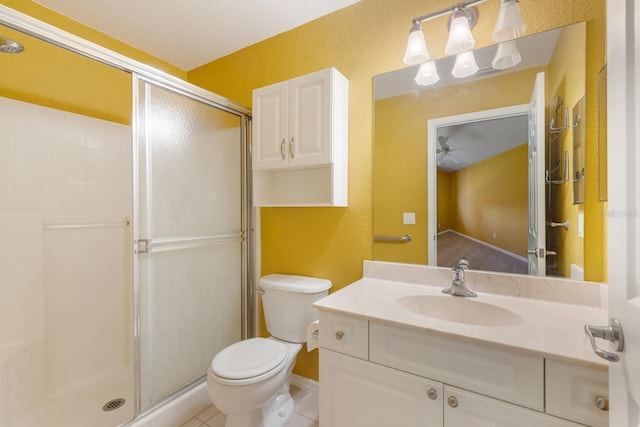 bathroom featuring walk in shower, tile patterned flooring, vanity, and toilet