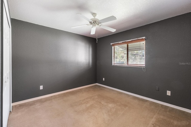 empty room with carpet and ceiling fan