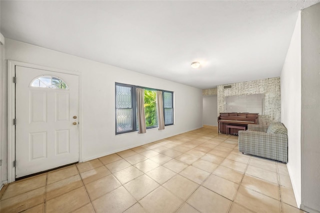 tiled foyer entrance with a healthy amount of sunlight