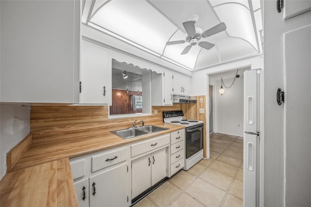 kitchen featuring white appliances, sink, ceiling fan, light tile patterned floors, and white cabinetry