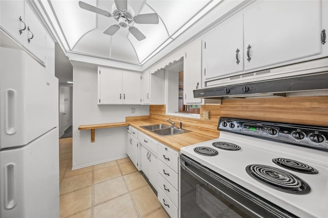 kitchen with white appliances, ceiling fan, sink, white cabinets, and light tile patterned flooring