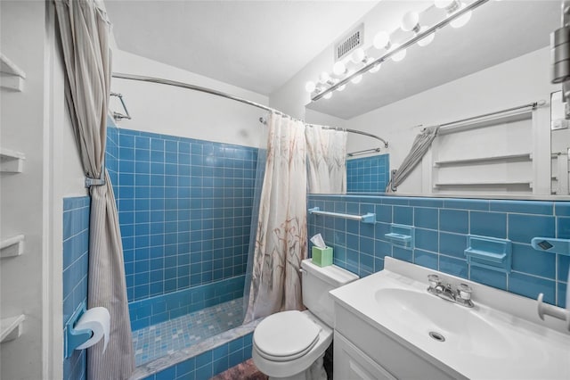 bathroom with toilet, vanity, tile walls, and walk in shower