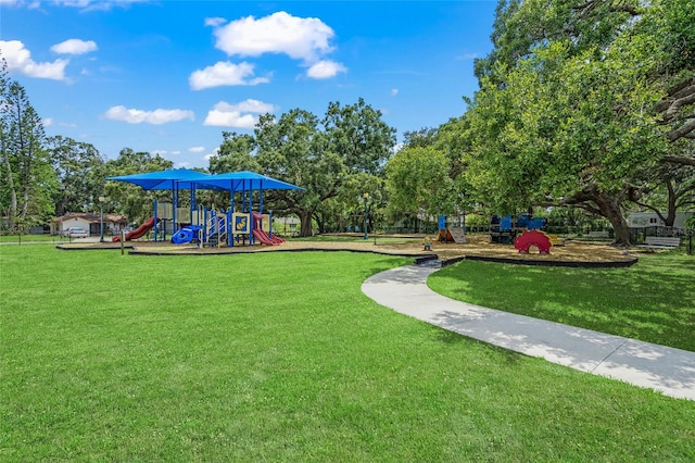 view of home's community with a lawn and a playground