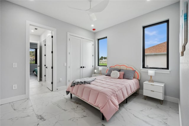 bedroom featuring ceiling fan and multiple windows