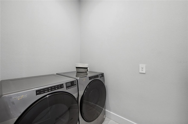 washroom featuring light tile patterned floors and washer and dryer