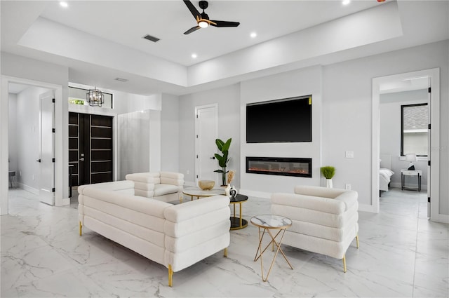 living area with visible vents, baseboards, ceiling fan with notable chandelier, marble finish floor, and recessed lighting