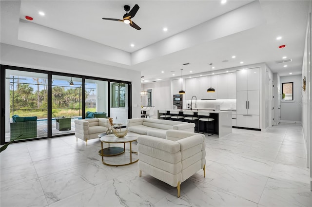 living area with marble finish floor, ceiling fan, recessed lighting, and visible vents