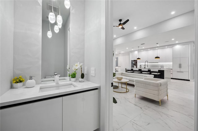 full bathroom featuring vanity, ceiling fan, recessed lighting, and marble finish floor