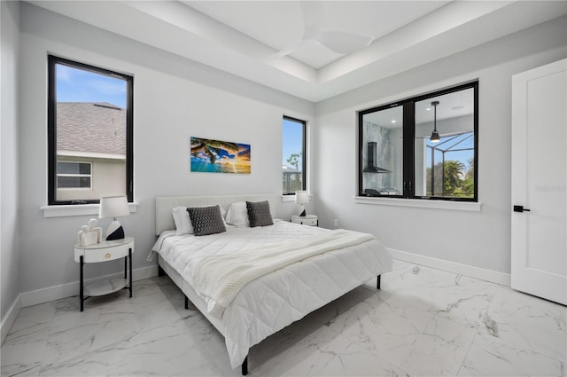 bedroom featuring baseboards, multiple windows, and marble finish floor