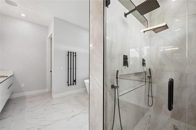 bathroom with a freestanding tub, baseboards, vanity, marble finish floor, and a marble finish shower