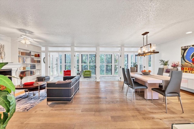 dining space featuring a wealth of natural light, floor to ceiling windows, and light hardwood / wood-style flooring