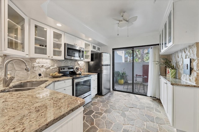 kitchen featuring white cabinets, sink, light stone counters, and stainless steel appliances