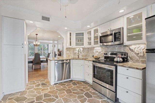 kitchen with white cabinetry, appliances with stainless steel finishes, sink, and light hardwood / wood-style flooring