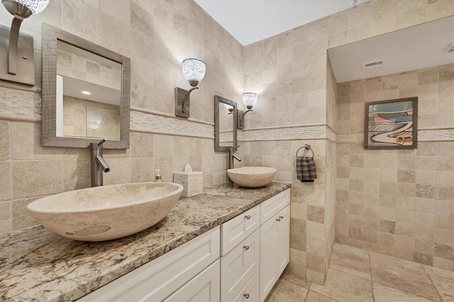 bathroom featuring vanity, backsplash, and tile walls