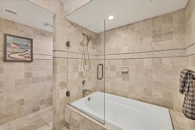 bathroom with independent shower and bath and tile walls