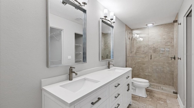 bathroom featuring toilet, an enclosed shower, and vanity