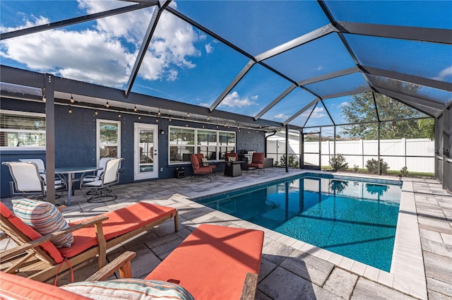 view of swimming pool with a patio and glass enclosure