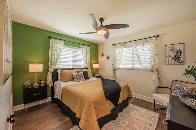 bedroom with ceiling fan and dark hardwood / wood-style flooring