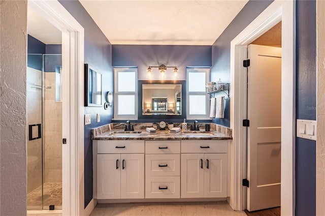 bathroom with vanity and a shower with shower door