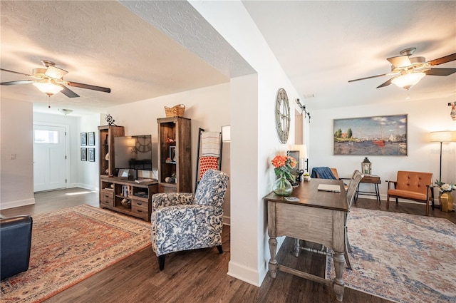 living room featuring a textured ceiling, dark hardwood / wood-style floors, and ceiling fan