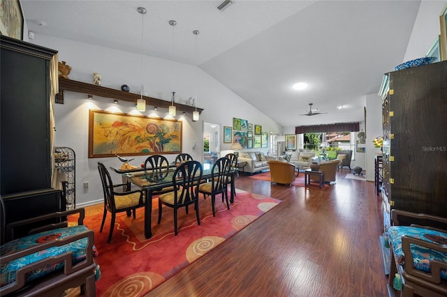 dining room with vaulted ceiling, ceiling fan, and dark hardwood / wood-style floors