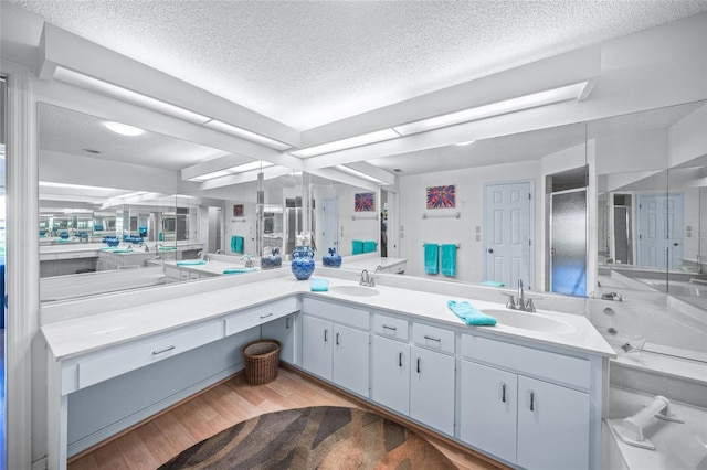 bathroom with vanity, hardwood / wood-style flooring, and a textured ceiling