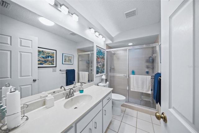 bathroom featuring an enclosed shower, vanity, a textured ceiling, and tile patterned flooring