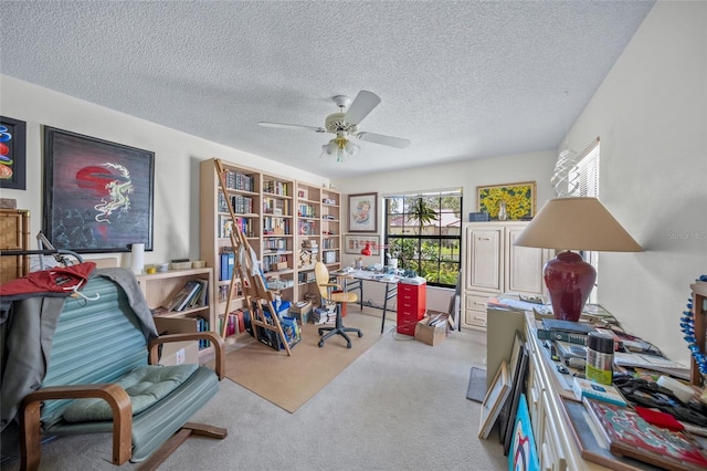 interior space with a textured ceiling and ceiling fan