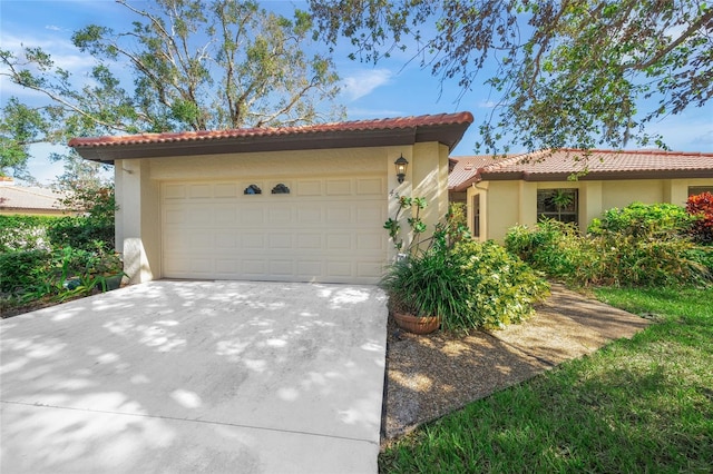 mediterranean / spanish-style home with a garage