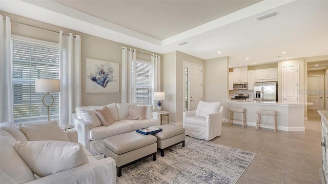 living room with plenty of natural light and light tile patterned floors