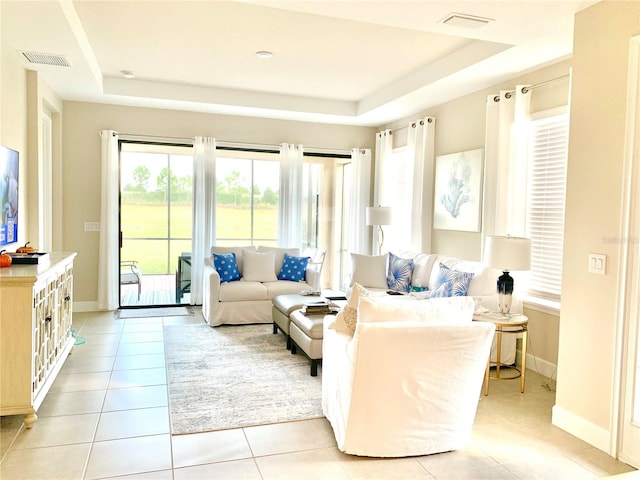 tiled living room with a tray ceiling