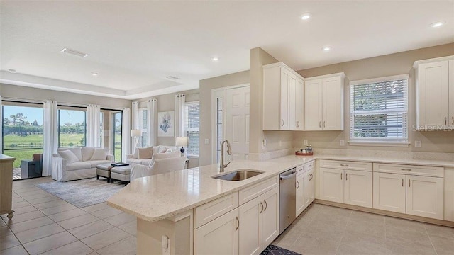 kitchen featuring dishwasher, kitchen peninsula, white cabinetry, and sink