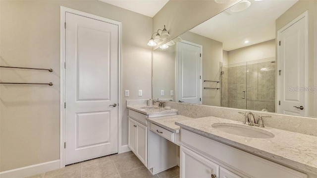 bathroom featuring tile patterned flooring, vanity, and a shower with door