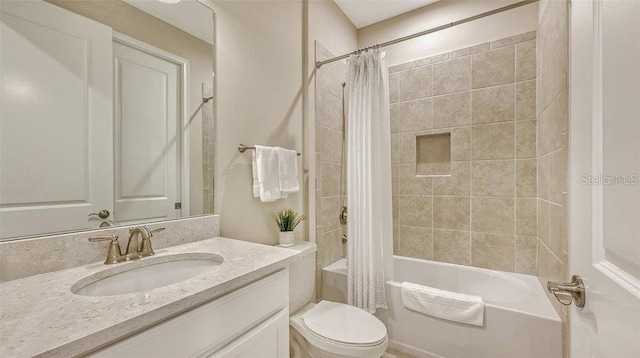 full bathroom featuring vanity, toilet, and shower / bath combination with curtain